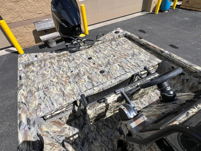 Slide: The Image of 2024 Ranger RB210 boat with camo design and Mercury outboard motor. - 9