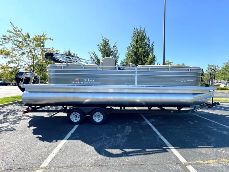 The Image of 2024 Sun Tracker Party Barge 24 DLX pontoon boat in parking lot. - 0