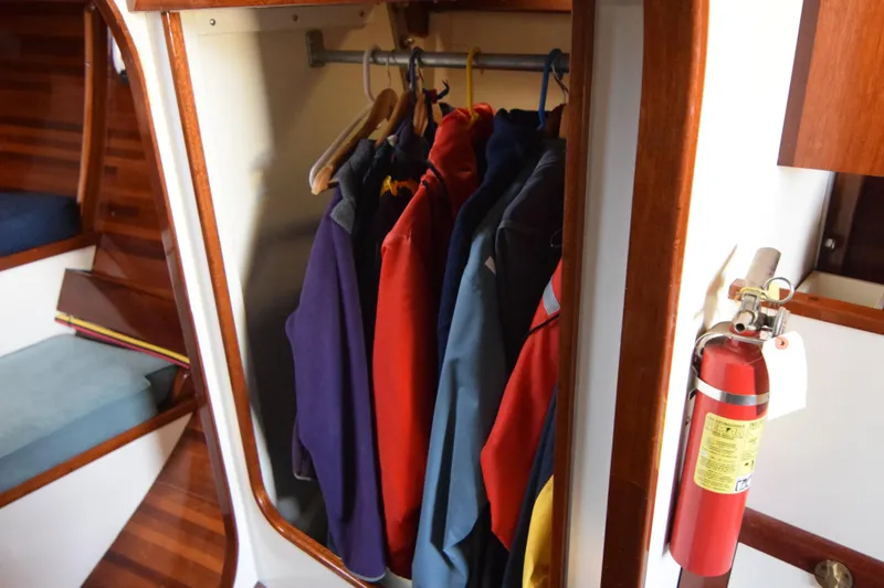 Slide: The Image of Closet with jackets on hangers inside a 2000 Custom Tumbleweed/Tony Skidmore 36 Fin Keel Cutter. - 19