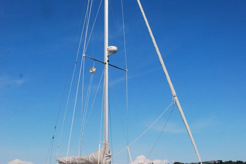 Slide: The Image of Sailboat with tall mast against clear blue sky, Custom Tumbleweed/Tony Skidmore 36 Fin Keel Cutter. - 30