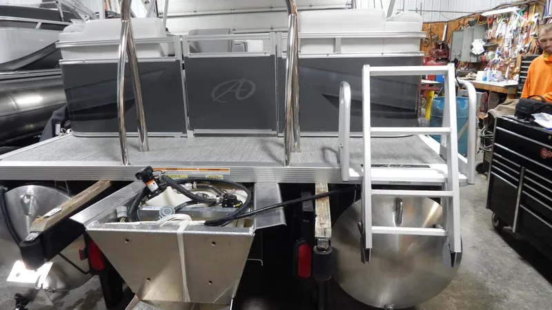 Slide: The Image of 2024 Avalon VLS Quad Lounge 21' pontoon boat rear view with ladder and deck. - 2