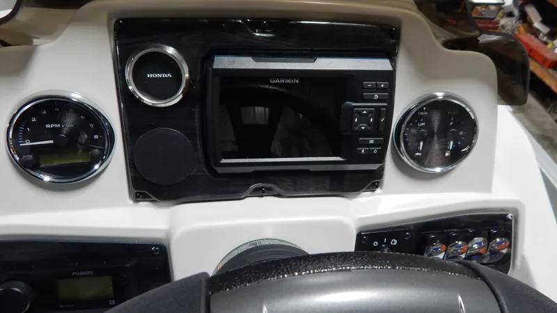 Slide: The Image of 2024 Avalon VLS Quad Lounge 21' boat dashboard with Garmin navigation system and Honda gauges. - 5