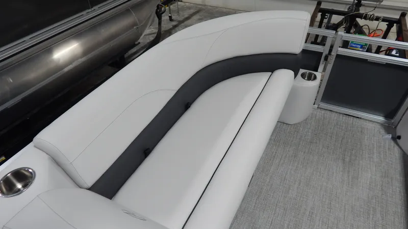 Slide: The Image of 2024 Avalon VLS Quad Lounge 21' interior seating with cup holders. - 7