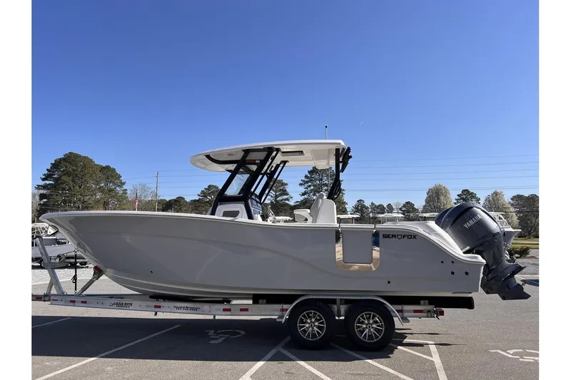 Slide: The Image of 2024 Sea Fox 288 Commander boat on trailer, side view, clear sky background. - 4