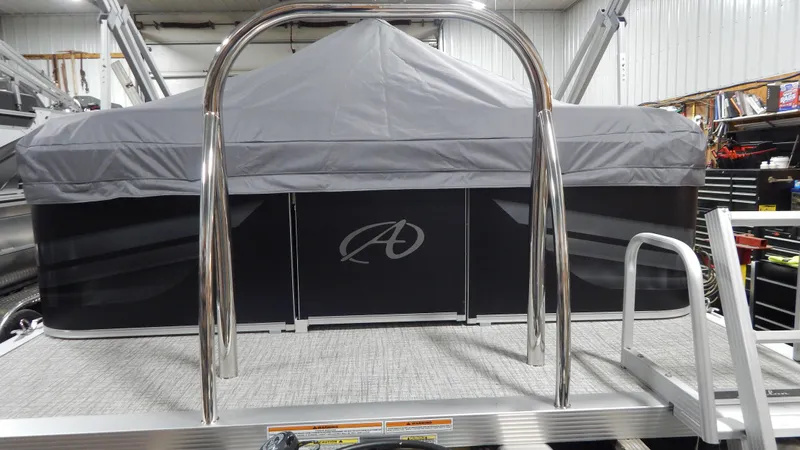 Slide: The Image of 2024 Avalon VLS Quad Lounge 21' pontoon boat with cover in storage. - 1