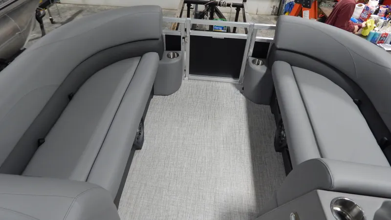 Slide: The Image of 2024 Avalon VLS Quad Lounge 21' interior with gray seating and carpet. - 3