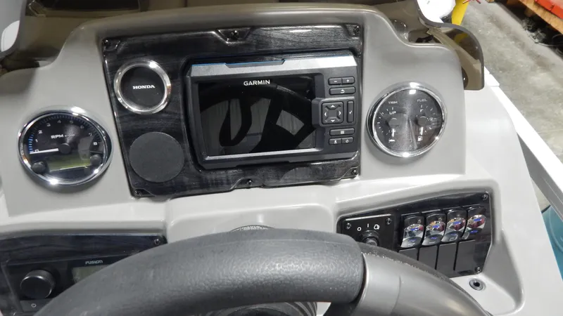 Slide: The Image of 2024 Avalon VLS Quad Lounge 21' boat dashboard with Garmin navigation system. - 5