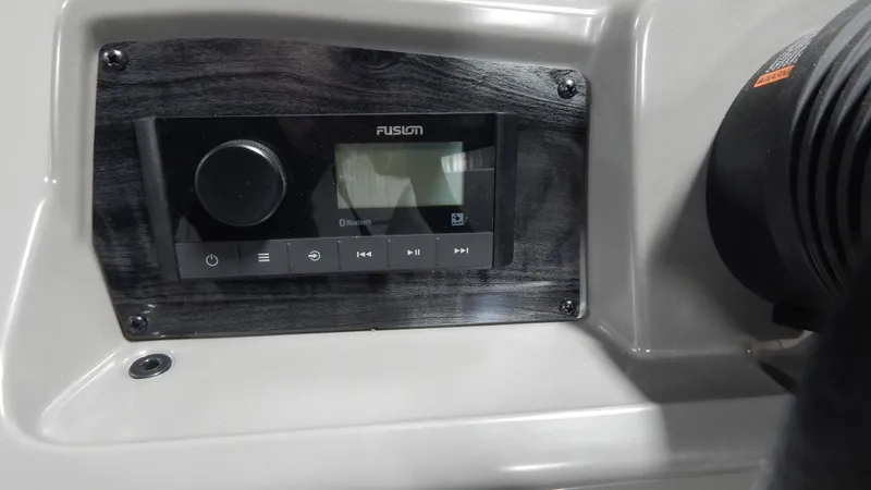 Slide: The Image of 2024 Avalon VLS Quad Lounge 21' boat dashboard with Fusion stereo system. - 7