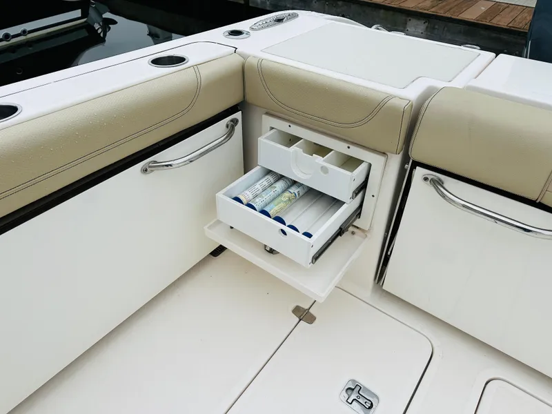 Slide: The Image of 2017 Pursuit OS 355 boat with open storage drawer on deck. - 10