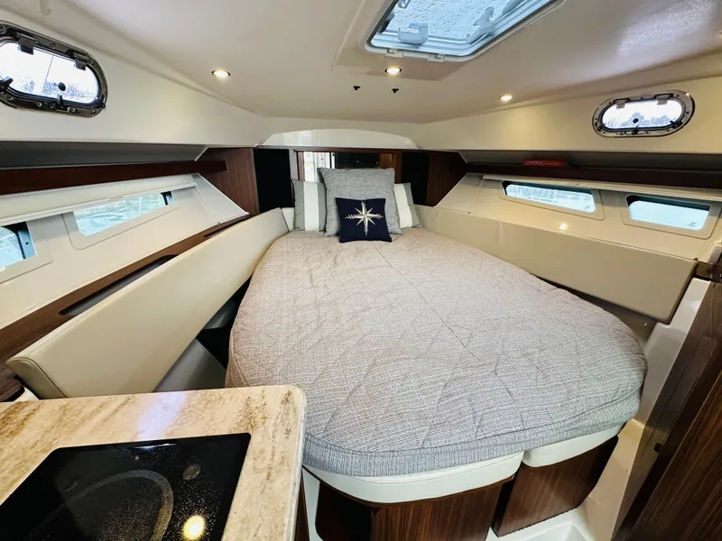 Slide: The Image of 2017 Pursuit OS 355 cabin interior with a cozy bed and modern amenities. - 29