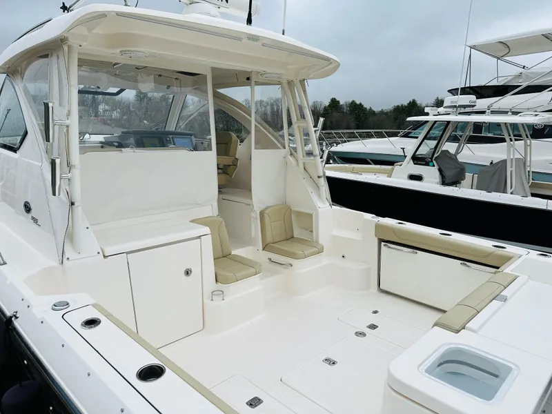 Slide: The Image of 2017 Pursuit OS 355 boat with spacious deck and seating area. - 3
