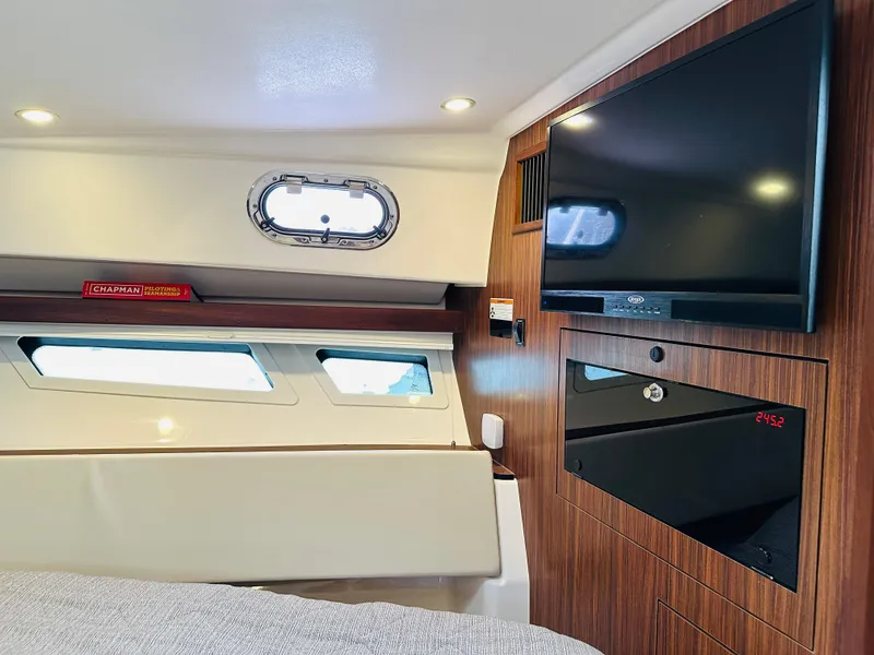 Slide: The Image of Interior cabin of 2017 Pursuit OS 355 with TV and porthole windows. - 30