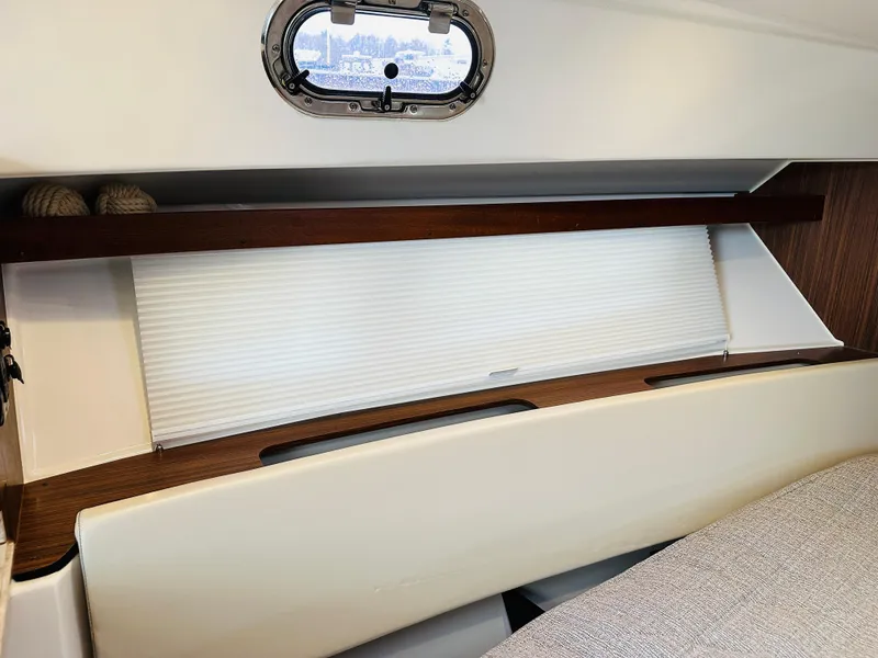 Slide: The Image of Interior cabin of a 2017 Pursuit OS 355 boat with window and shelf. - 34