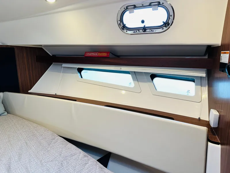 Slide: The Image of Interior cabin of 2017 Pursuit OS 355 boat with windows and shelf. - 35