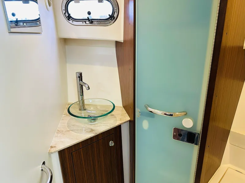 Slide: The Image of 2017 Pursuit OS 355 bathroom with glass sink and frosted door. - 41