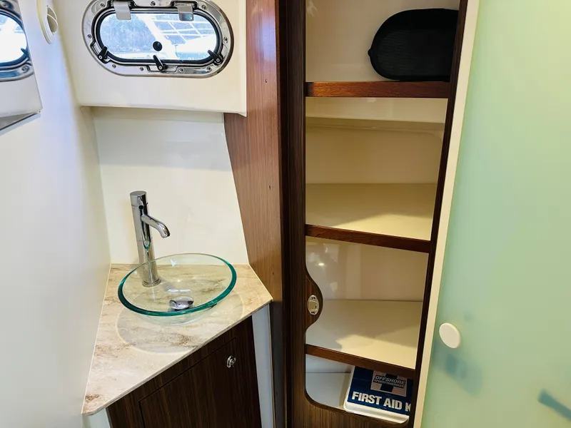 Slide: The Image of 2017 Pursuit OS 355 bathroom with sink, faucet, and storage shelves. - 42