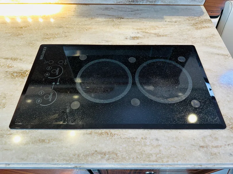 Slide: The Image of Glass cooktop on marble countertop in 2017 Pursuit OS 355 boat kitchen. - 46