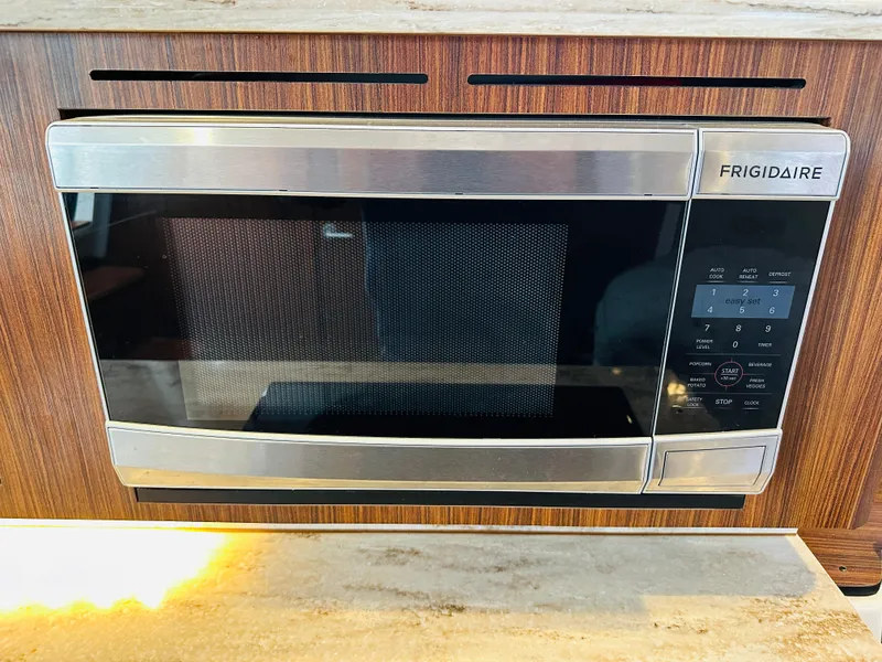Slide: The Image of Frigidaire microwave installed in a 2017 Pursuit OS 355 boat kitchen. - 47