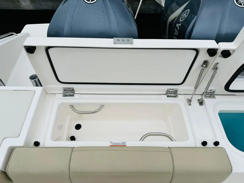 Slide: The Image of 2017 Pursuit OS 355 boat with open storage compartment and twin Yamaha engines. - 6