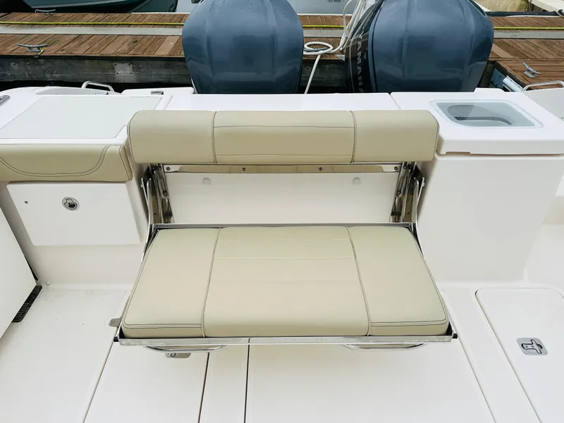 Slide: The Image of 2017 Pursuit OS 355 boat with foldable bench seat and twin outboard motors. - 8