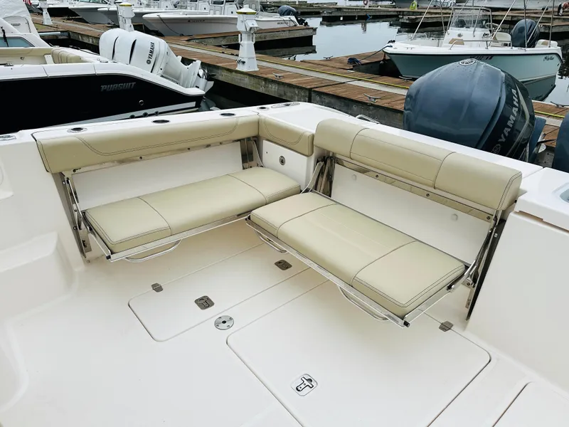 Slide: The Image of 2017 Pursuit OS 355 boat with foldable seating at the dock. - 9