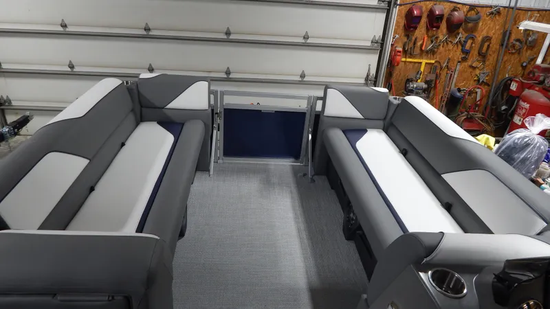 Slide: The Image of 2024 Avalon Venture Quad Lounge Tritoon interior with gray and white seating. - 6