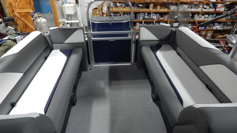 Slide: The Image of 2024 Avalon Venture Quad Lounge Tritoon interior with gray and white seating. - 7