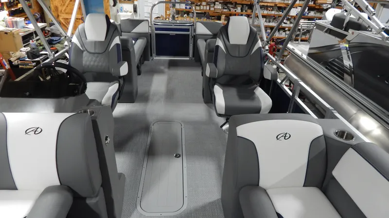 Slide: The Image of 2024 Avalon Venture Quad Lounge Tritoon interior with gray and white seating. - 8