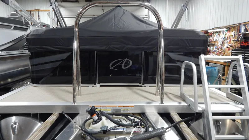 Slide: The Image of 2024 Avalon VLS Quad Lounge 23' pontoon boat in a storage facility. - 3