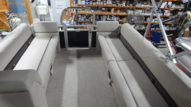 Slide: The Image of 2024 Avalon VLS Quad Lounge 23' interior with beige seating in a workshop. - 4