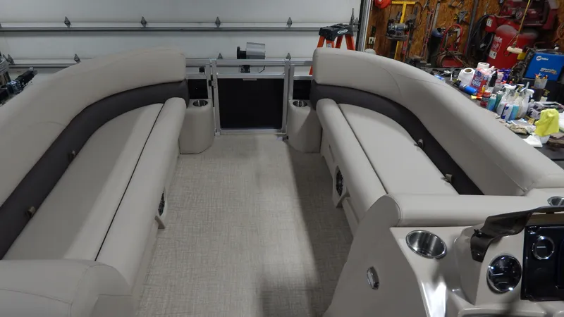 Slide: The Image of 2024 Avalon VLS Quad Lounge 23' interior with beige seating and modern dashboard. - 6