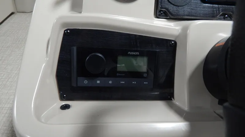 Slide: The Image of 2024 Avalon VLS Quad Lounge 23' boat dashboard with Fusion audio system. - 7