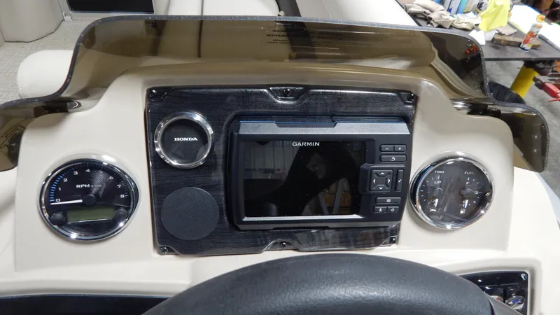 Slide: The Image of 2024 Avalon VLS Quad Lounge 23' dashboard with Garmin navigation system. - 8