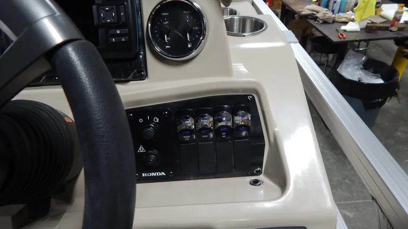 Slide: The Image of 2024 Avalon VLS Quad Lounge 23' boat dashboard with steering wheel and control panel. - 9