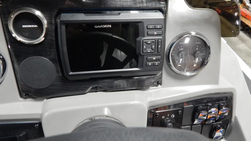 Slide: The Image of 2024 Avalon VLS Quad Lounge 21' boat dashboard with Garmin navigation system. - 10