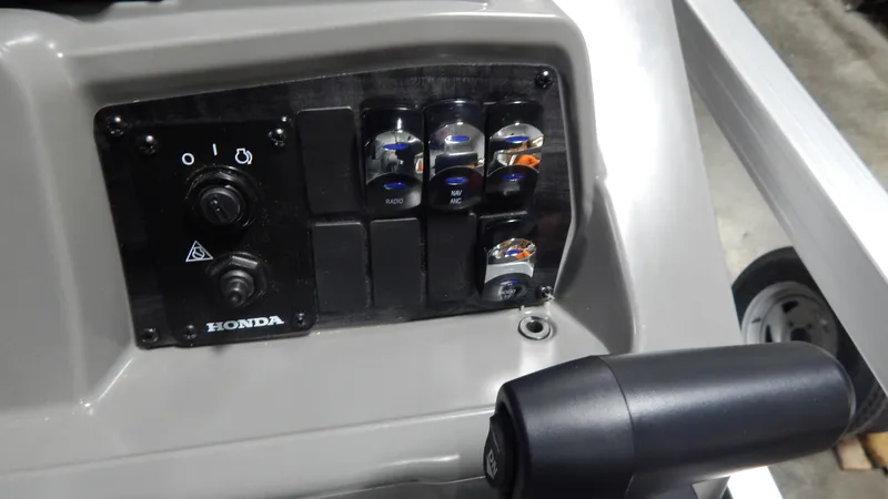 Slide: The Image of Control panel of 2024 Avalon VLS Quad Lounge 21' boat with Honda engine. - 11
