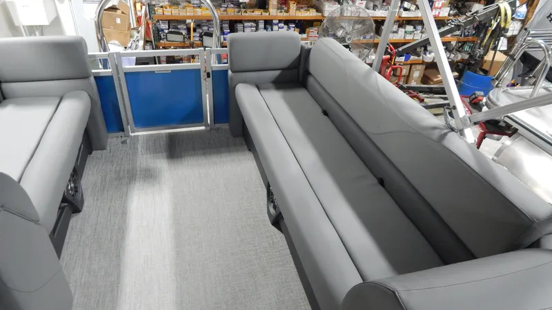 Slide: The Image of 2024 Avalon VLS Quad Lounge 21' interior with gray seating and blue accents. - 6