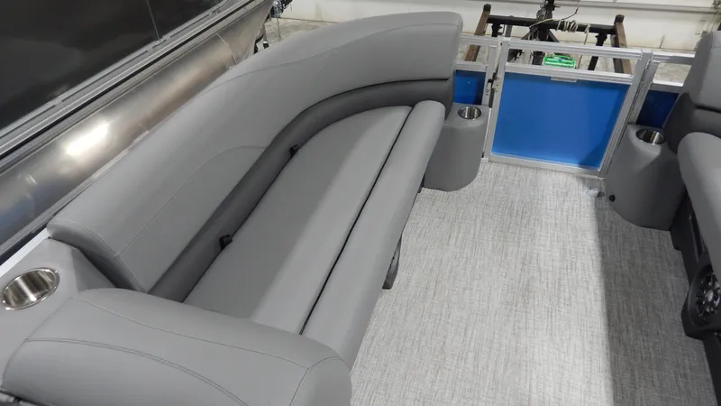 Slide: The Image of 2024 Avalon VLS Quad Lounge 21' interior with gray seating and cup holders. - 7