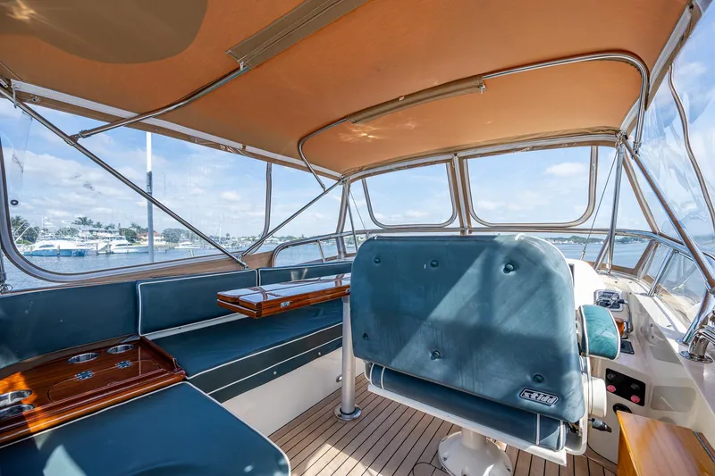 Slide: The Image of 2008 Hinckley Talaria 44 FB yacht interior with blue seating and wooden accents. - 11