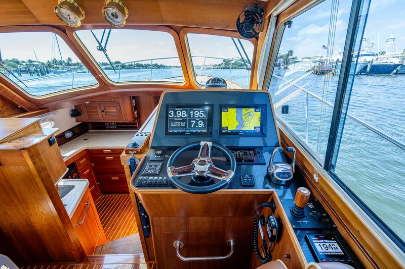 Slide: The Image of Helm of 2008 Hinckley Talaria 44 FB yacht with navigation screens and wooden interior. - 15