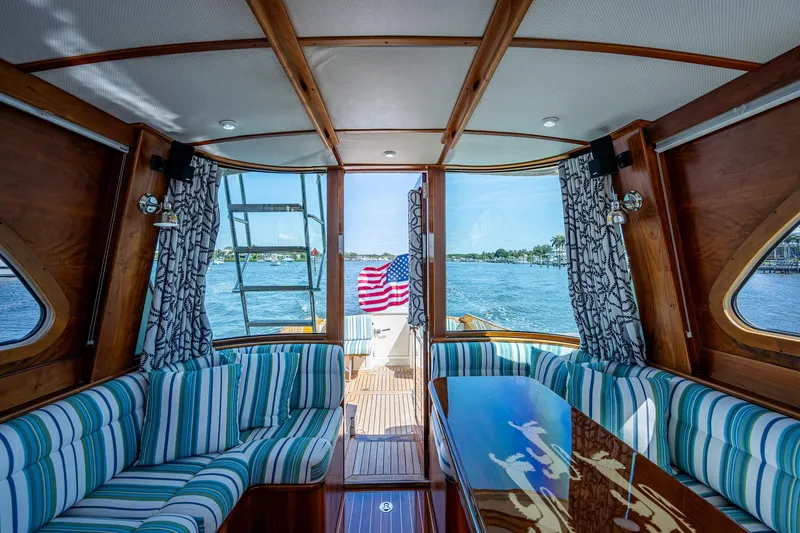 Slide: The Image of Interior of 2008 Hinckley Talaria 44 FB yacht with striped seating and scenic water view. - 19