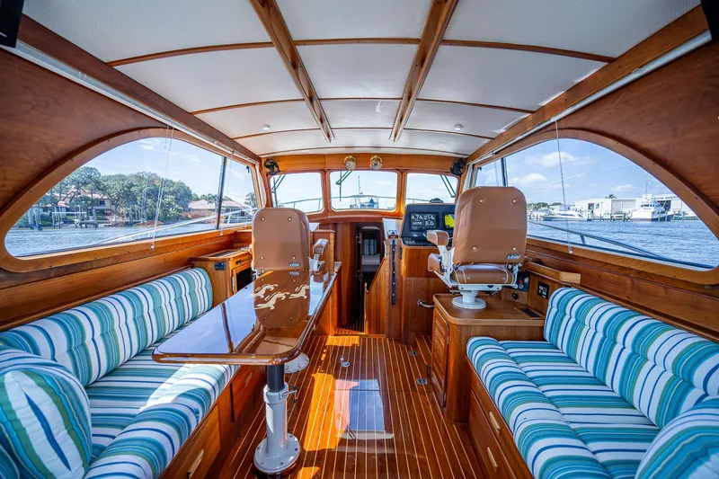 Slide: The Image of Interior of 2008 Hinckley Talaria 44 FB yacht with striped seating and wooden finishes. - 2