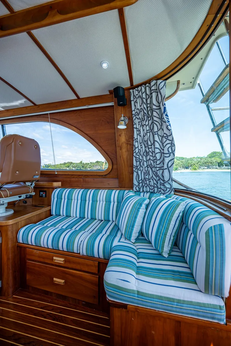 Slide: The Image of Interior of 2008 Hinckley Talaria 44 FB with striped seating and wooden accents. - 20