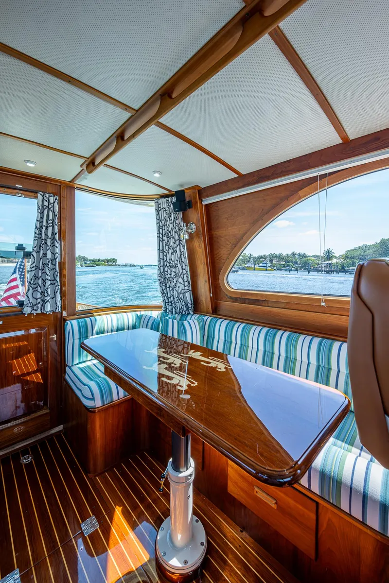 Slide: The Image of Interior of 2008 Hinckley Talaria 44 FB yacht with striped seating and polished wood table. - 22