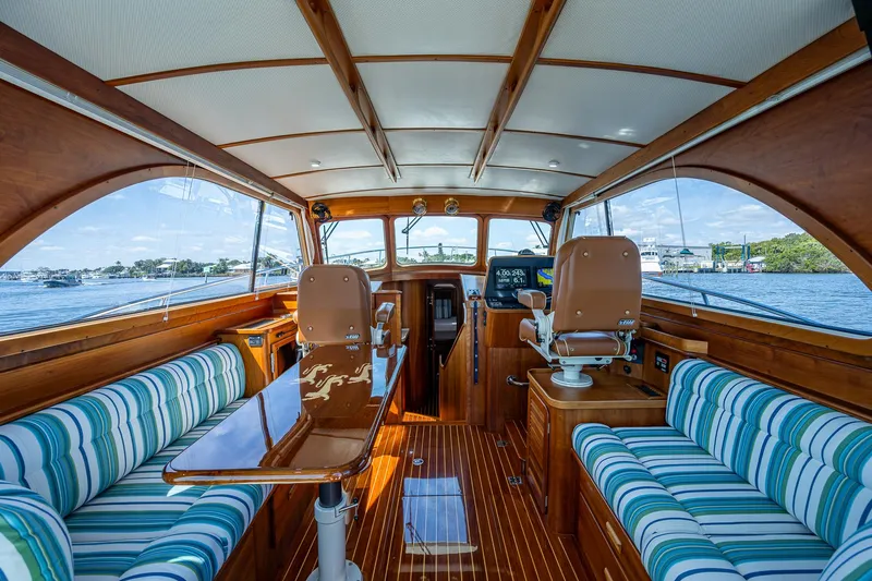 Slide: The Image of Luxurious 2008 Hinckley Talaria 44 FB yacht interior with striped seating and wooden finishes. - 23