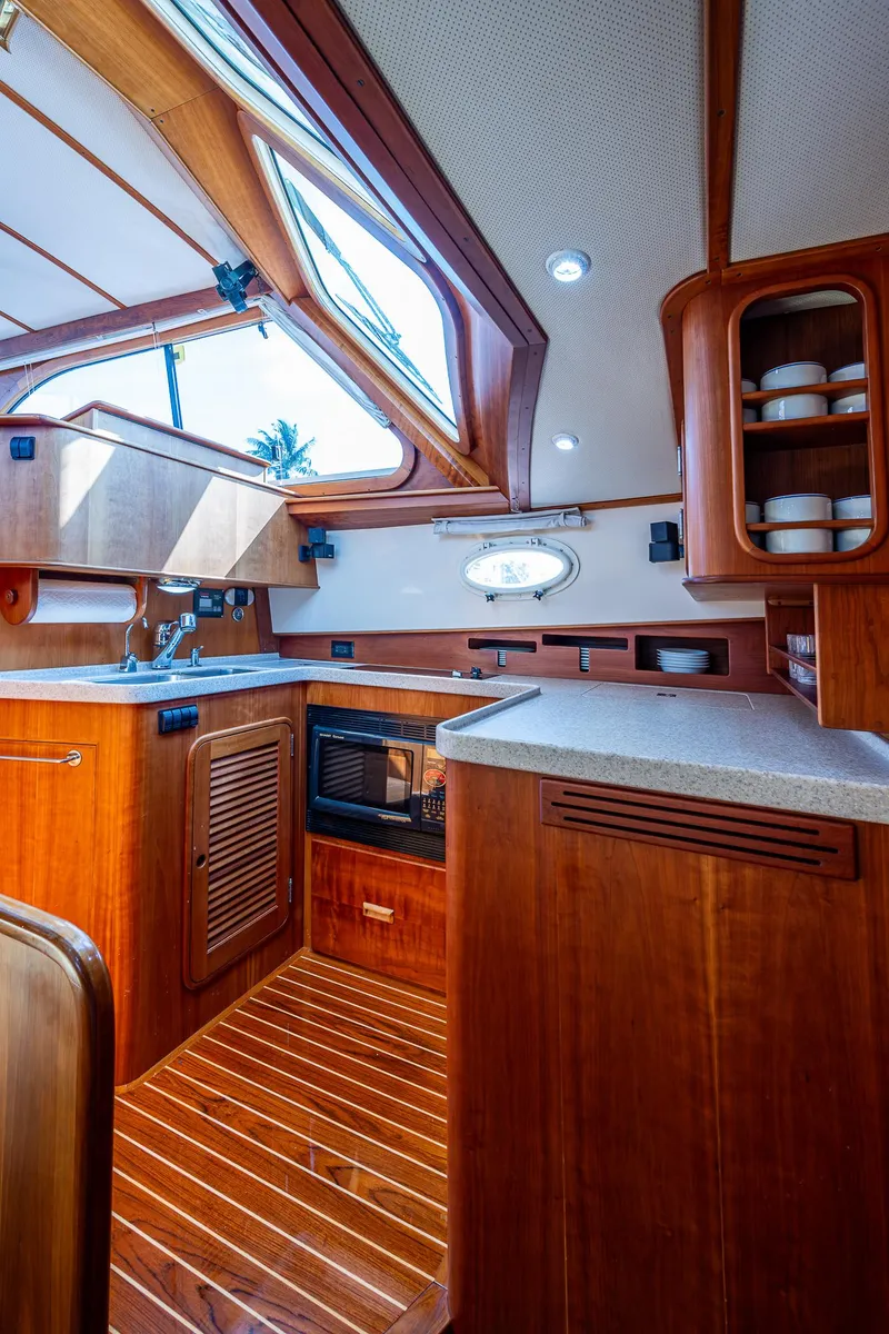 Slide: The Image of Luxurious 2008 Hinckley Talaria 44 FB yacht interior with wooden cabinetry and modern amenities. - 25