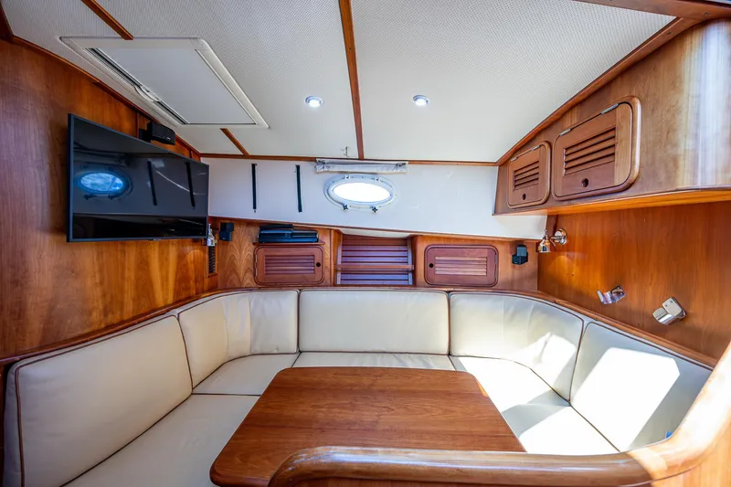Slide: The Image of Interior of 2008 Hinckley Talaria 44 FB yacht with wood paneling and beige seating. - 26