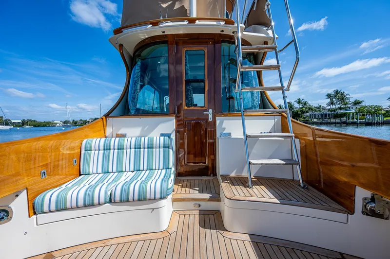 Slide: The Image of 2008 Hinckley Talaria 44 FB yacht deck with striped seating and ladder. - 3