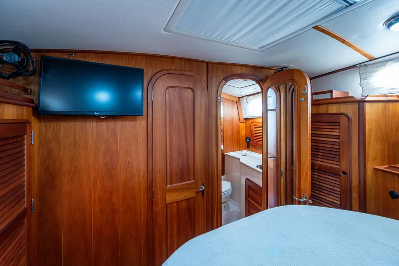 Slide: The Image of Hinckley Talaria 44 FB 2008 yacht interior with wood paneling, TV, and bathroom. - 30