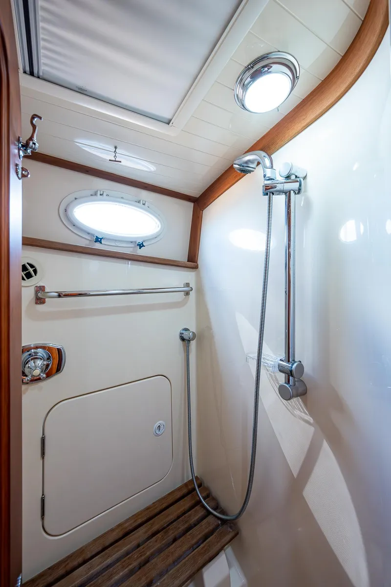 Slide: The Image of Shower area in 2008 Hinckley Talaria 44 FB yacht with wooden accents and porthole window. - 32